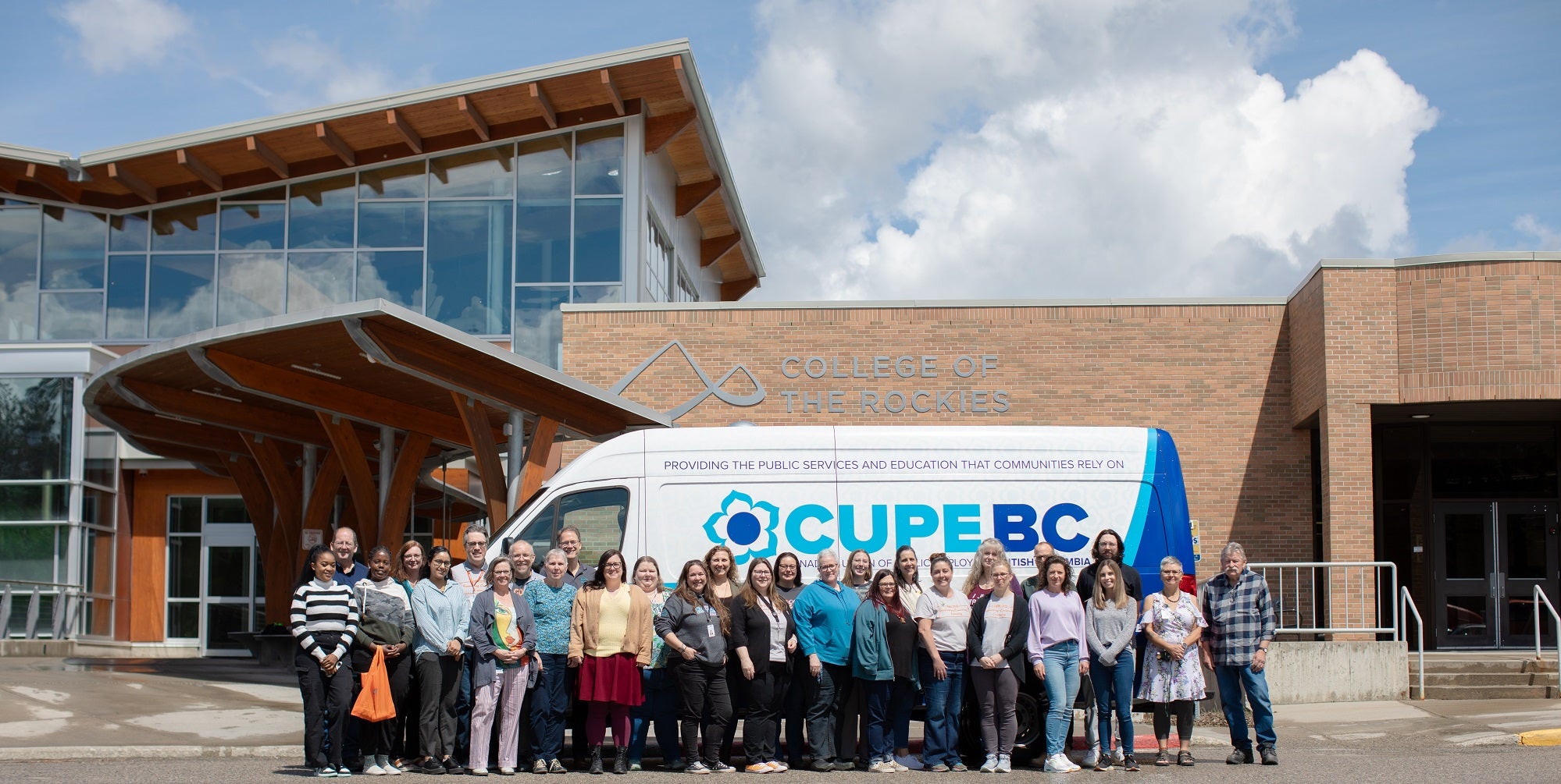 Group of College of the Rockies CUPE members standing in front of CUPE BC bus.